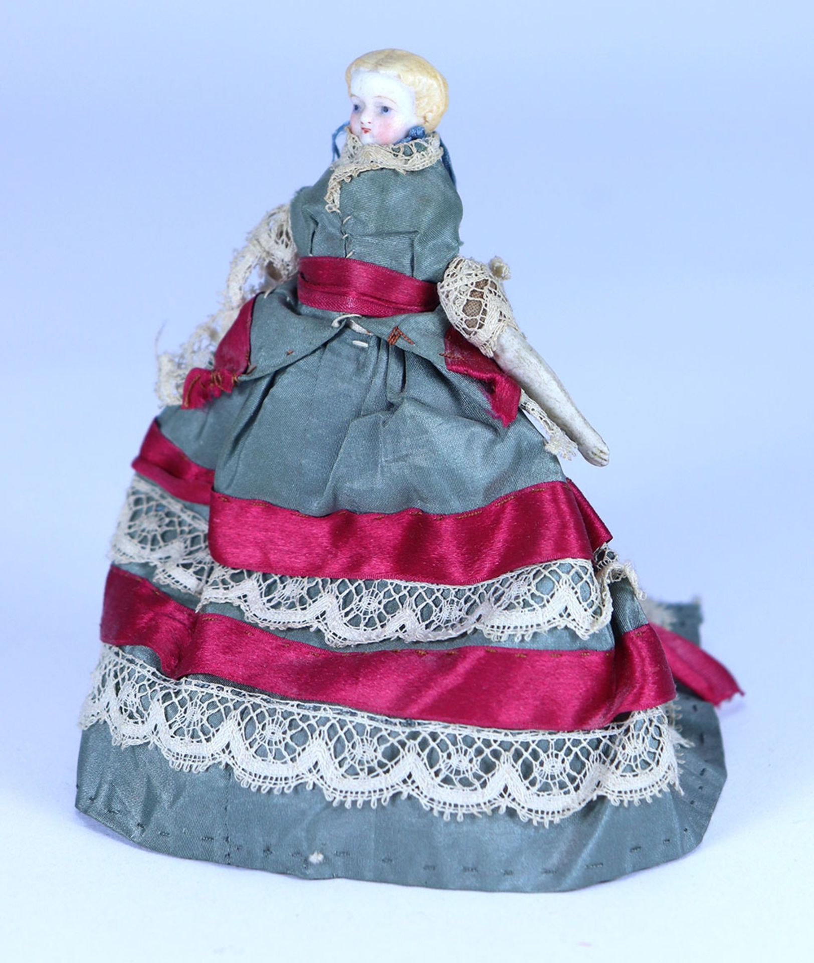 A miniature Parian-type bisque shoulder head doll in original clothes, German circa 1850,