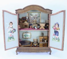 A charming wooden miniature dolls house in French armoire style, circa 1890,