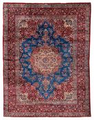 Persian Kirman blue and crimson ground carpet