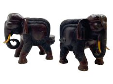 Pair of mid-to-late 20th century carved hardwood 'dug-out' chairs in the form of elephants
