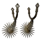 Pair of South American gaucho steel and brass spurs with twenty-two spike heel rowels