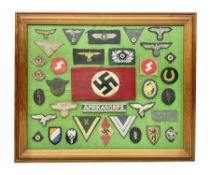 Framed display of thirty-four WWII German cloth badges including Luftwaffe pilot