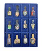 Twelve French military metal badges mounted on leather fobs including Legion