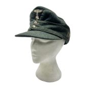 WWII German M43 field cap with 'SS' cloth badge and mountain trooper's edelweiss metal badge