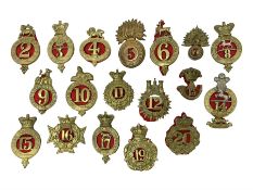 Eighteen regimental cap badges