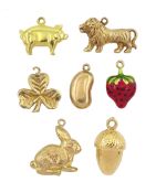 Seven 9ct gold pendant / charms including lion