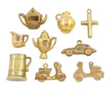 Nine 9ct gold pendant / charms including scooter