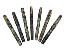 Seven marbleised fountain pens