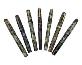 Seven marbleised fountain pens