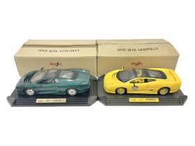 Two Maisto 1:12 scale cars comprising 1992 Jaguar XJ220 Racing car in yellow and 1992 Jaguar XJ220 i