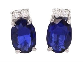 Pair of 18ct white gold oval cut sapphire and round brilliant cut diamond stud earrings