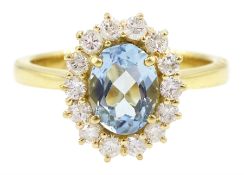 18ct gold oval cut aquamarine and round brilliant cut diamond cluster ring