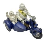 Cast iron figure of Michelin Man on motorbike modelled with smaller seated Michelin man in side car