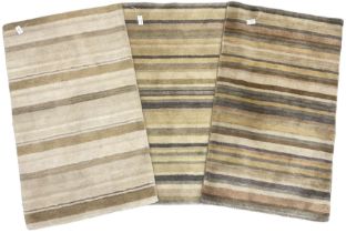 Three contemporary striped rugs in green