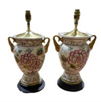 Pair of table lamps with floral decoration and gilt twin handles on a circular wooden base