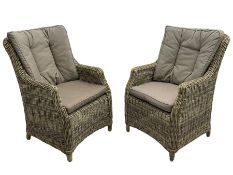 Pair of conservatory rattan armchairs with loose cushions