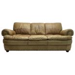 Large three-seat sofa upholstered in stitched brown leather with stud work decoration