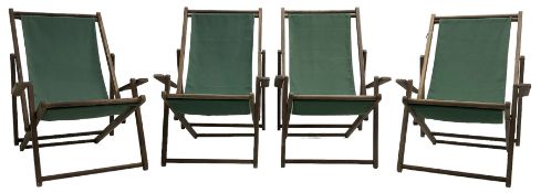 Set of four wooden folding deck chairs with slug green fabric seats
