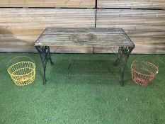 Cast iron and wood slatted garden table and pair of metal hanging baskets