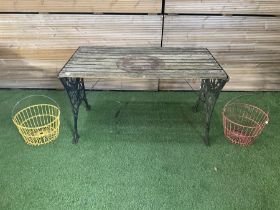 Cast iron and wood slatted garden table and pair of metal hanging baskets