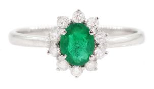 18ct white gold oval cut emerald and round brilliant cut diamond cluster ring