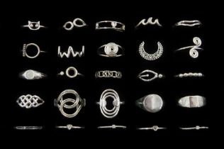 Twenty-five silver rings including crescent