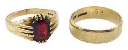 Gold single stone garnet ring and a gold wedding band