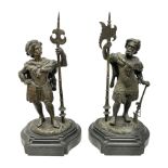 Pair of bronzed figure modelled as a hunter in traditional dress