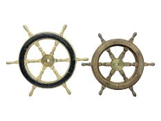 Two wooden ships wheels