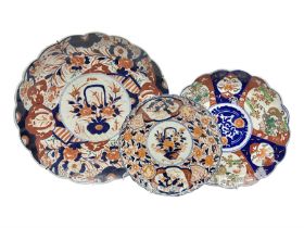 Three Japanese Imari chargers with scalloped edges