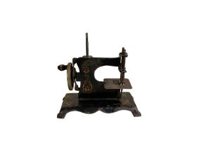 Miniature tinplate sewing machine