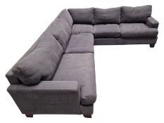 Large corner sofa upholstered in grey fabric