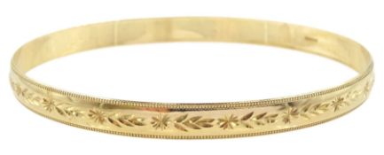 9ct gold bangle with engraved decoration