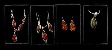 Silver amber jewellery including three necklaces and two pairs of pendant earrings
