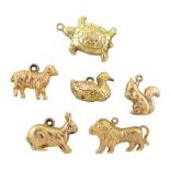 Six 9ct gold pendant / charms including duck