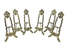 Set of six ornate cast brass easel stands