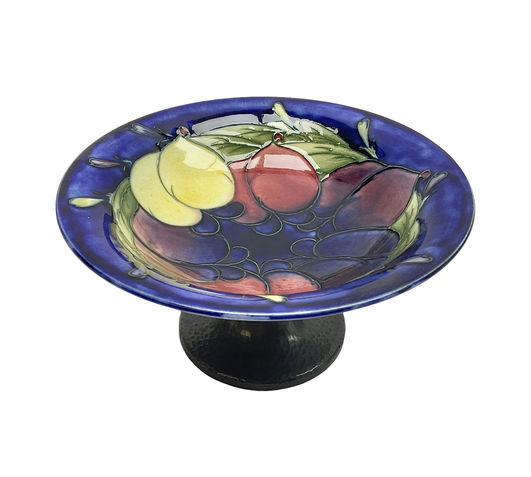 Moorcroft small pedestal dish decorated in the Wisteria pattern against a dark blue ground raised to