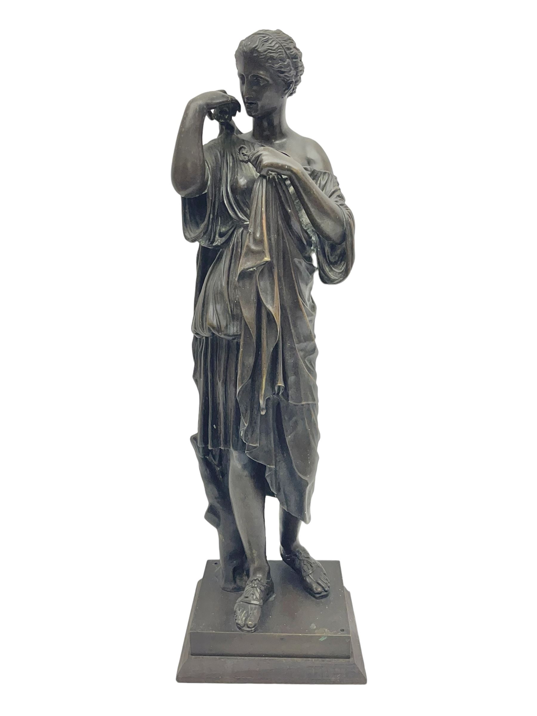 Bronzed figure of a woman in neoclassical dress