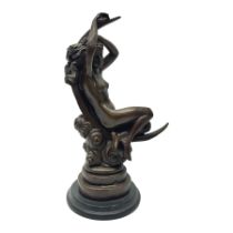 Bronze figure modelled as a nude female figure seated on a crescent moon
