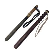 Two wooden truncheon with turned grips and leather straps
