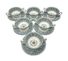 Six Wedgwood Florentine pattern twin handled soup bowls and saucers