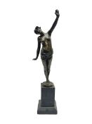 Bronzed semi nude female figure with one hand raised