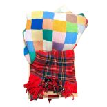 Multicoloured knitted patchwork blanket and a tartan blanket