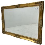 Swept gilt framed wall mirror with rectangular bevelled plate