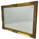 Swept gilt framed wall mirror with rectangular bevelled plate