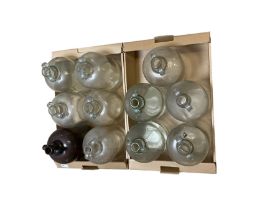 Eleven glass demijohns