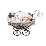 Three porcelain dolls and a wicker dolls pram with lace cover