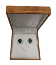Pair of silver cubic zirconia and green stone oval cluster stud earrings