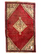 Small Persian red ground rug