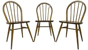 Ercol - 1960s set of three elm and beech 'Windsor' stick and hoop back chairs